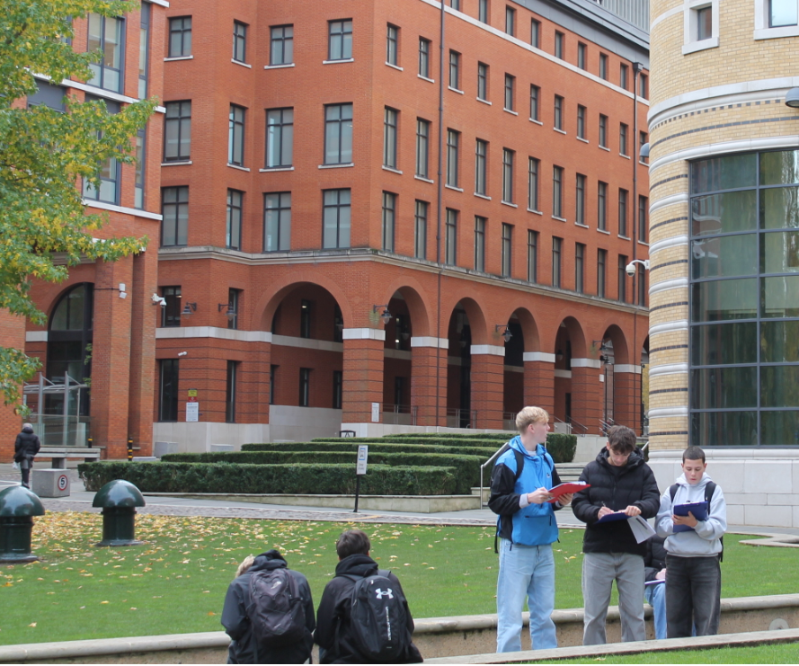 A group of students people standing outside of a building in Birmingham completing fieldwork