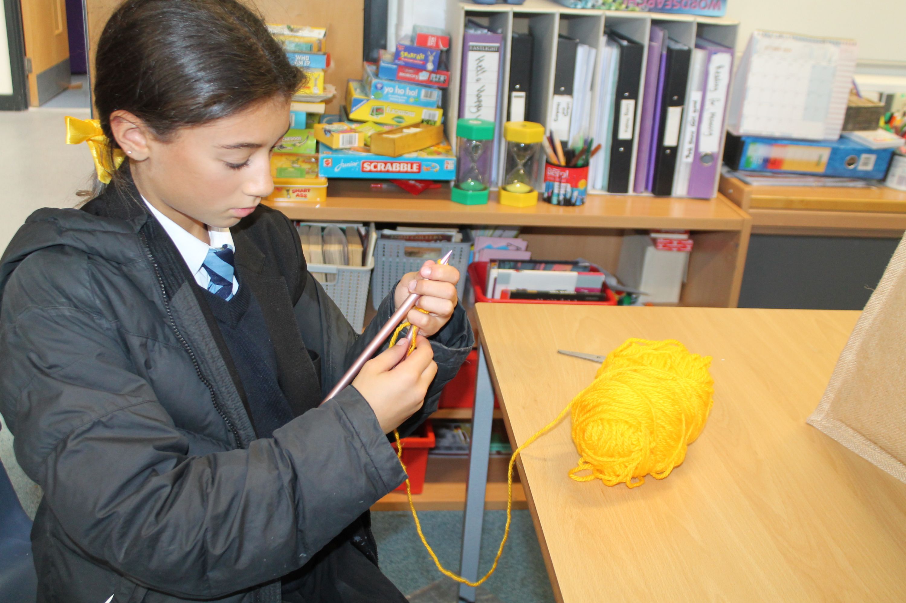 A student  knitting, one of the activities available to support Young Minds  - Hello Yellow 