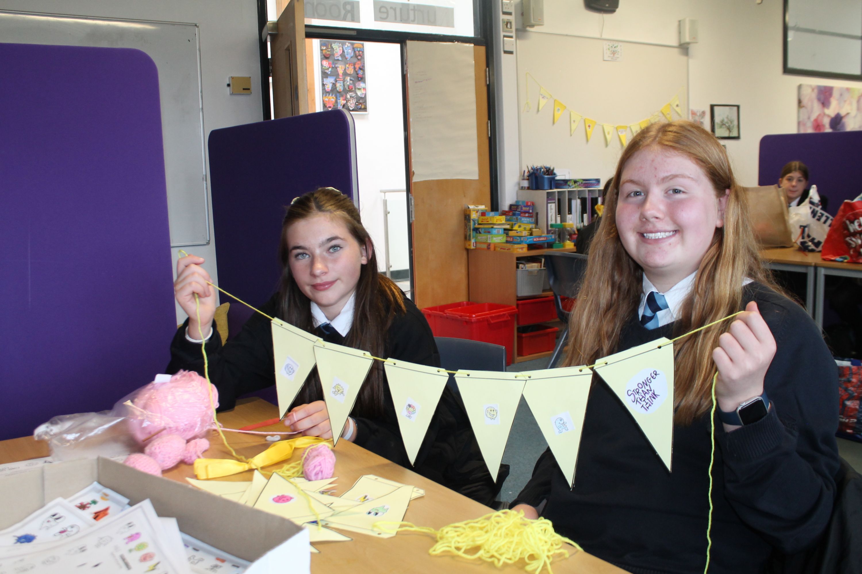 Two students making bunting decorations  to support Young Minds  - Hello Yellow 