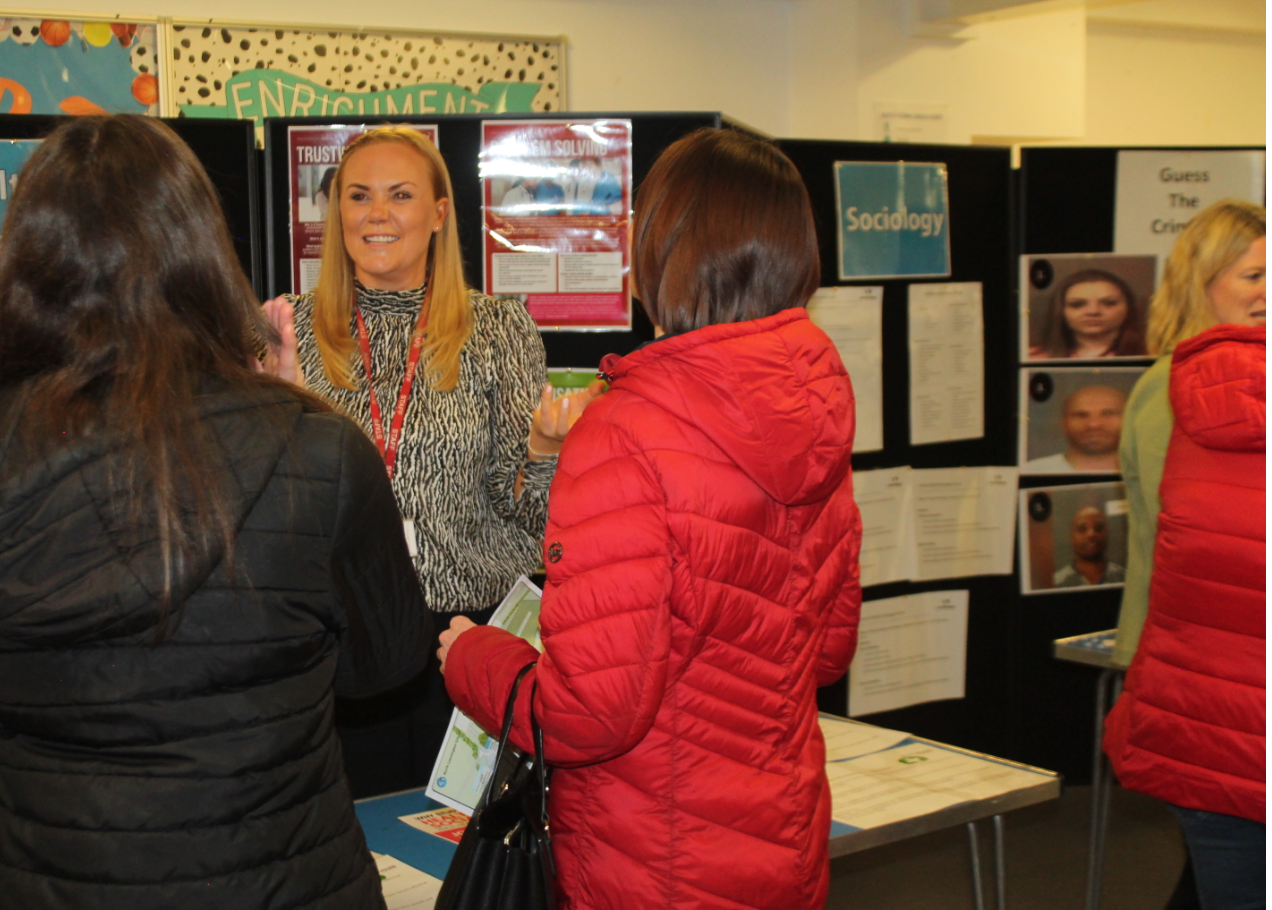 Sociolofy and Health and Social Care teachers talking about their subjects with visitors