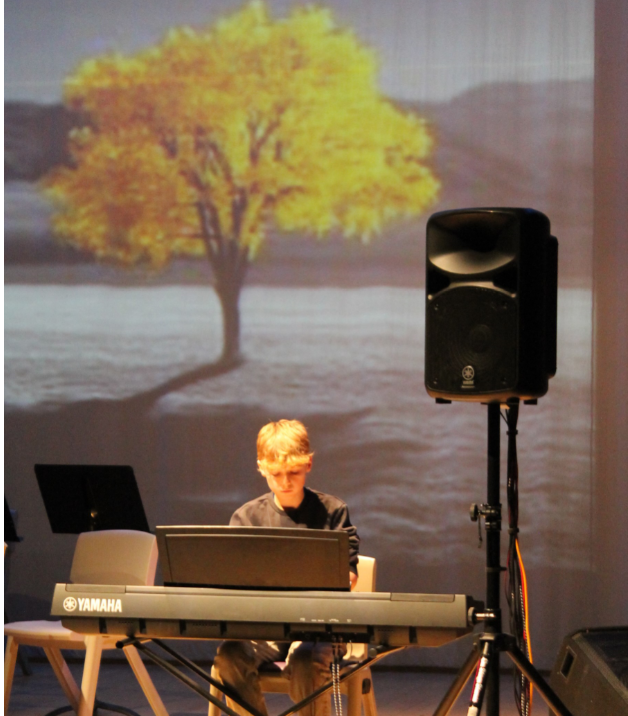 A student performing a solo piece at the music concert