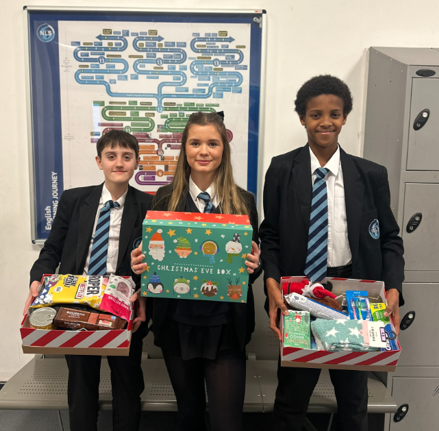 Three students with their Tutor Group Christmas hamper  