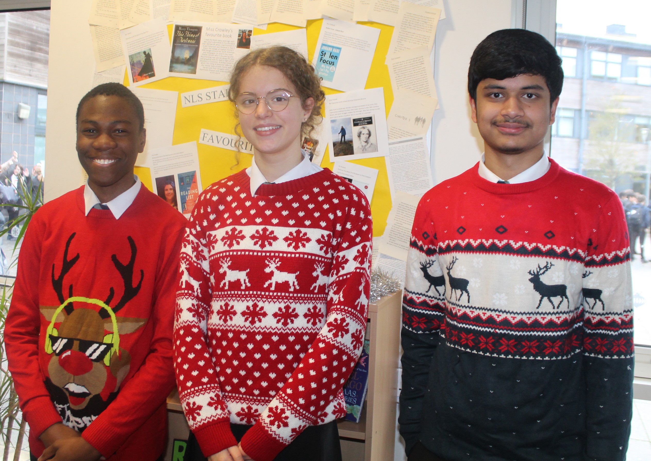 Three students wearing Christmas jumpers to raise money for Save the Children