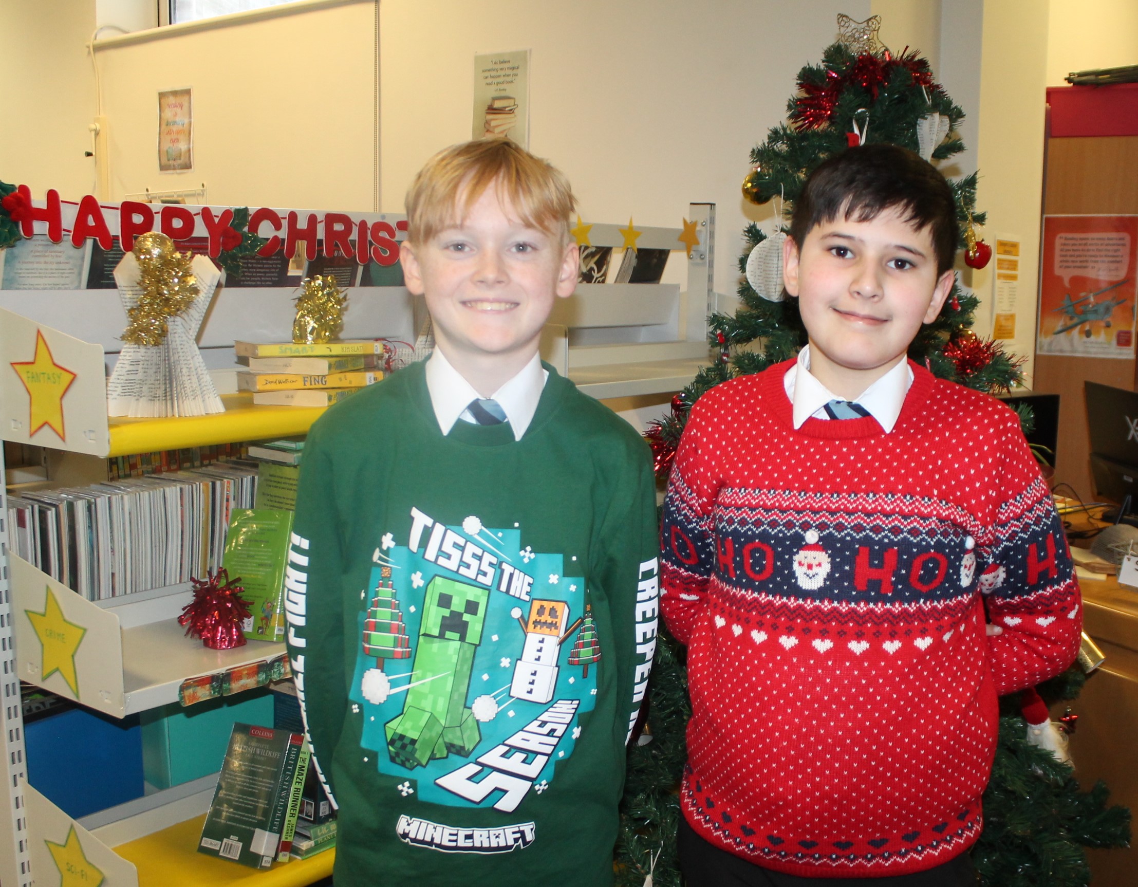 Two students wearing Christmas jumpers to raise money for Save the Children