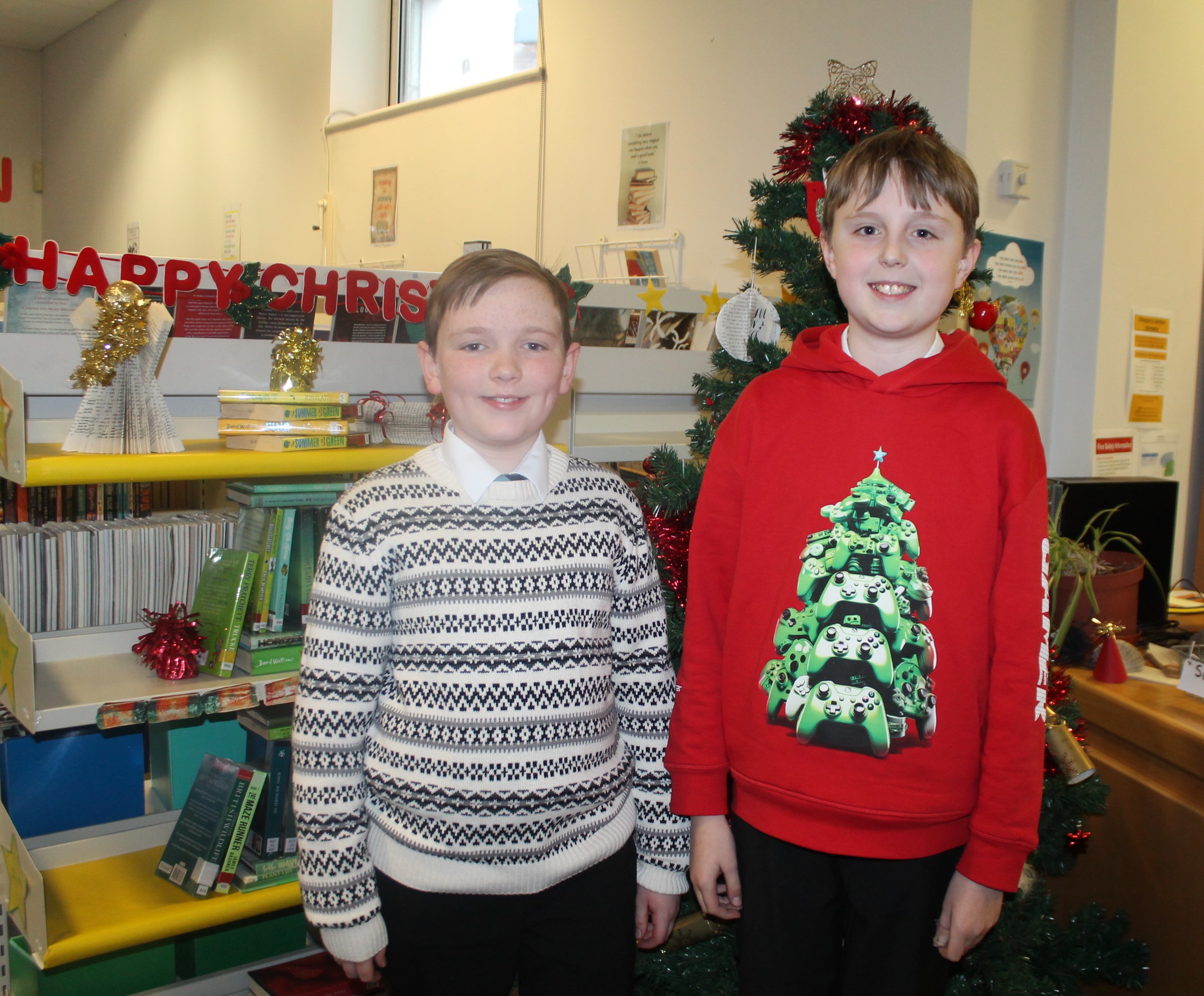 Two students wearing Christmas jumpers to raise money for Save the Children