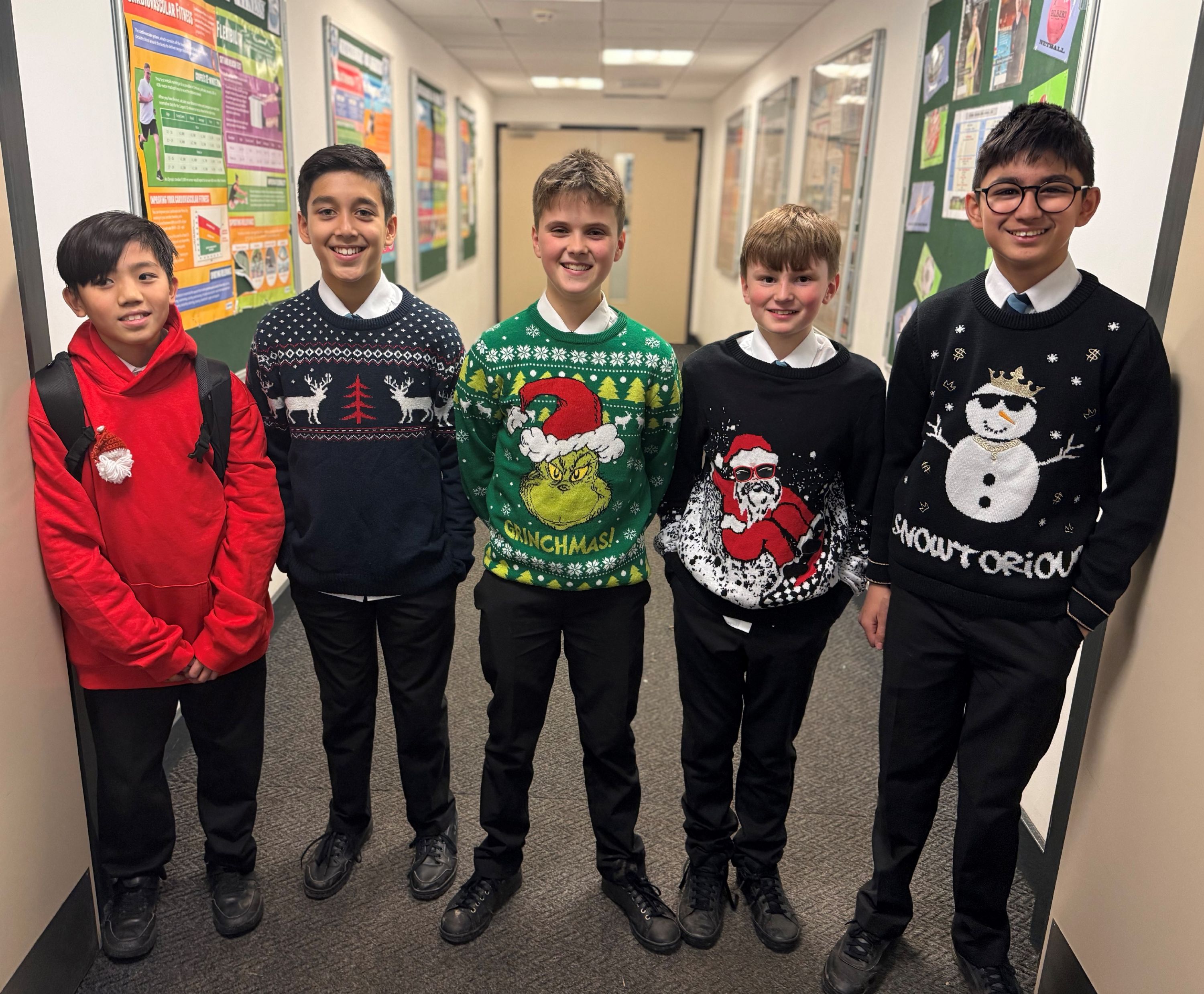 Five students wearing Christmas jumpers to raise money for Save the Childrens