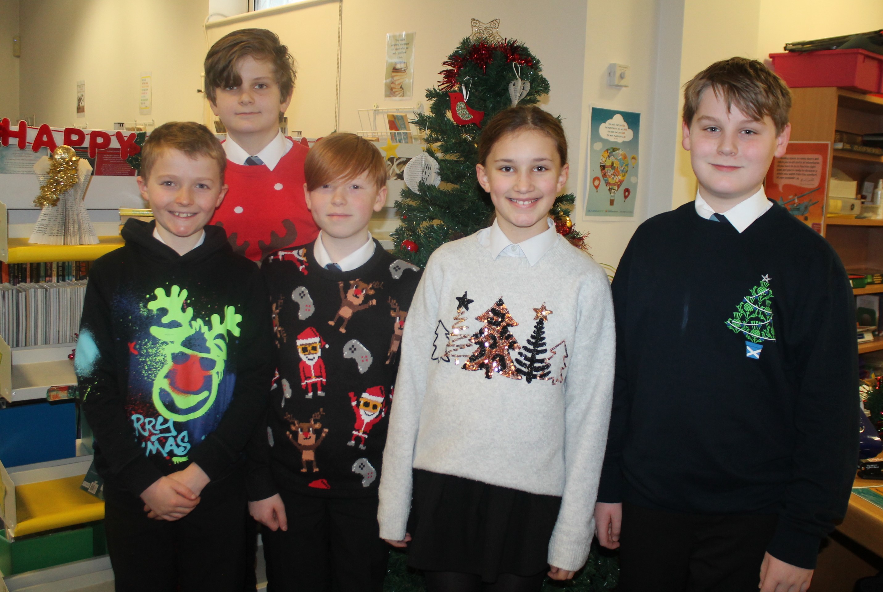 Five students wearing Christmas jumpers to raise money for Save the Children