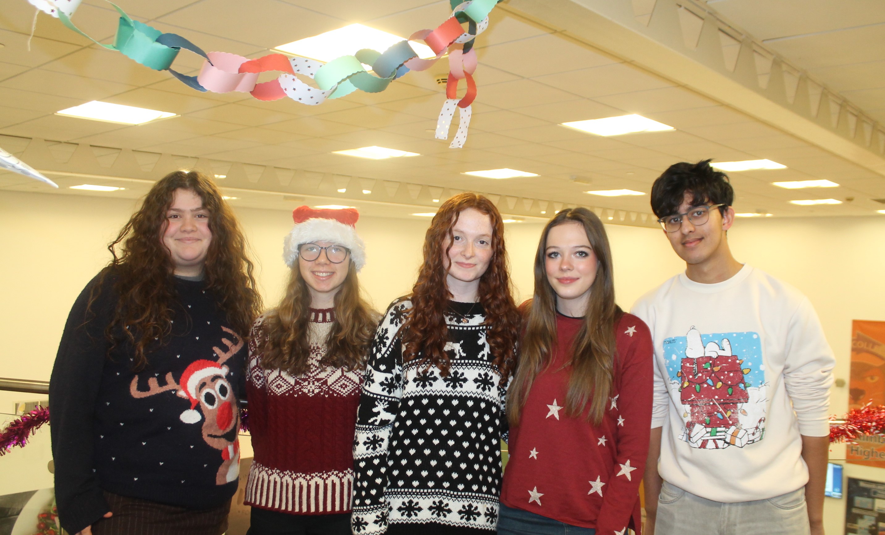 Five students wearing Christmas jumpers to raise money for Save the Children