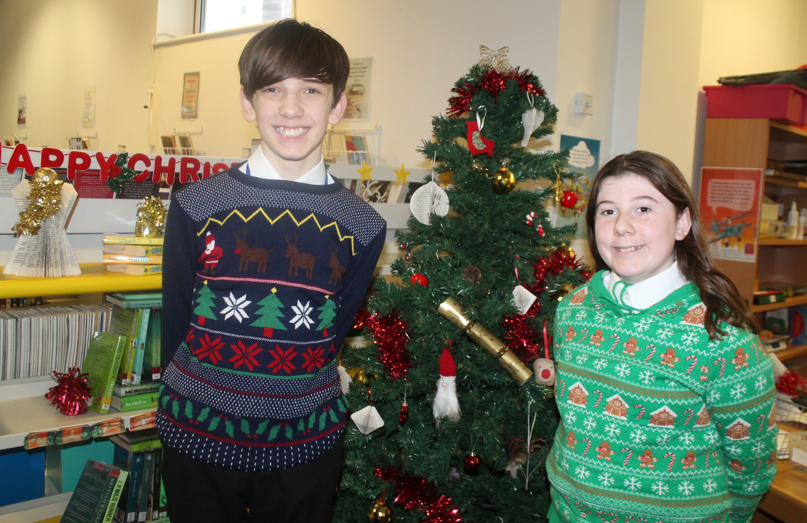 Two students wearing Christmas jumpers to raise money for Save the Children