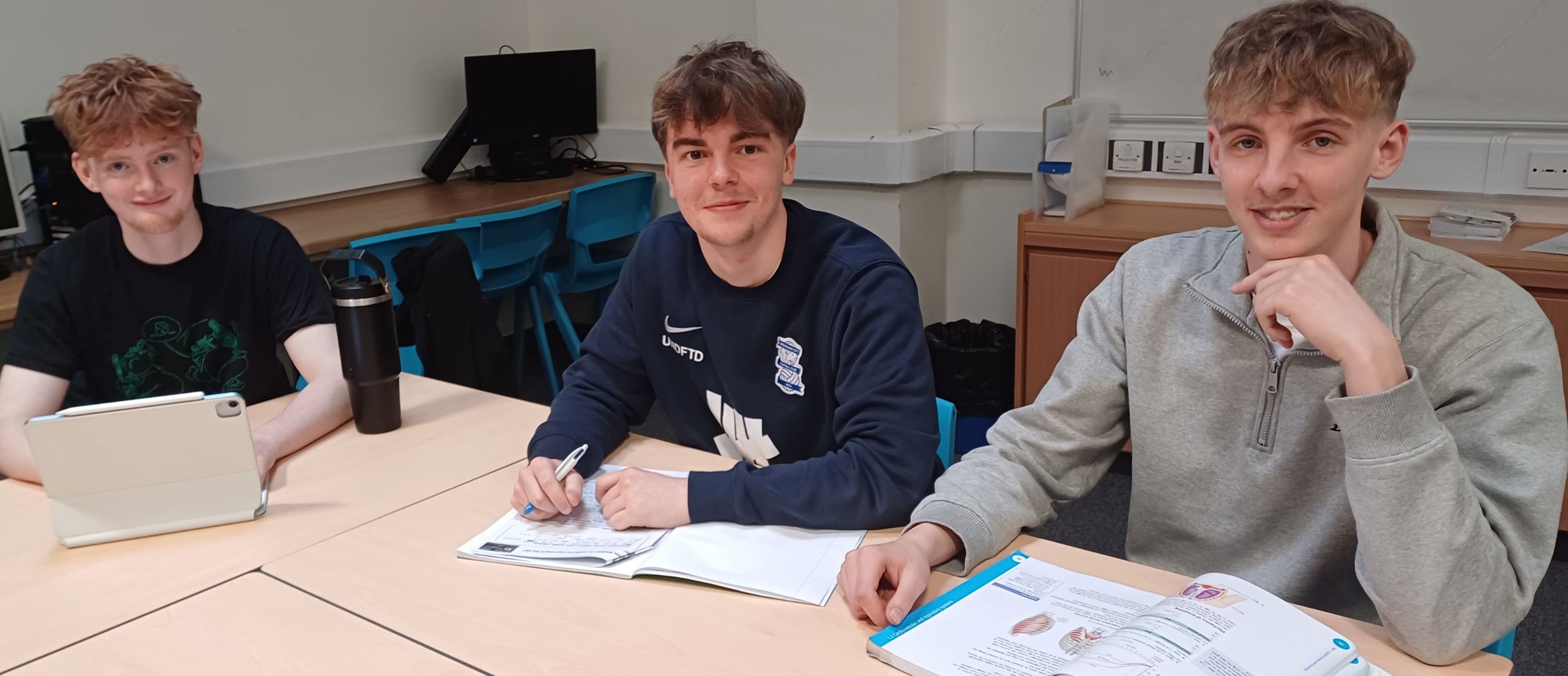 three students at desk in the new sixth form study area