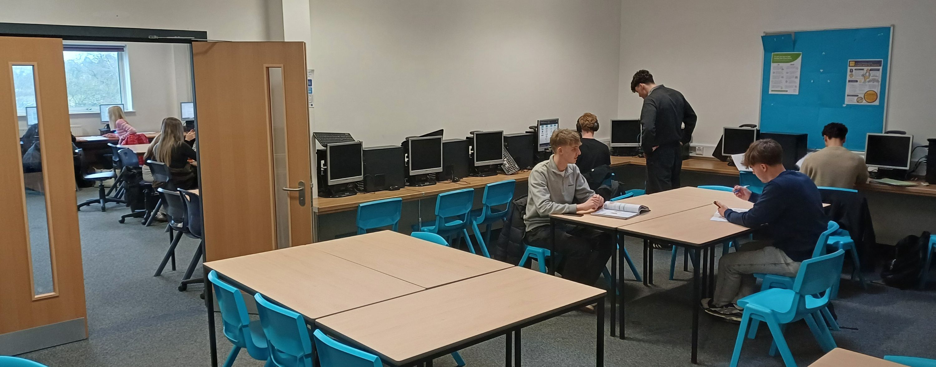 students sitting around deaks in the new sixth form study area