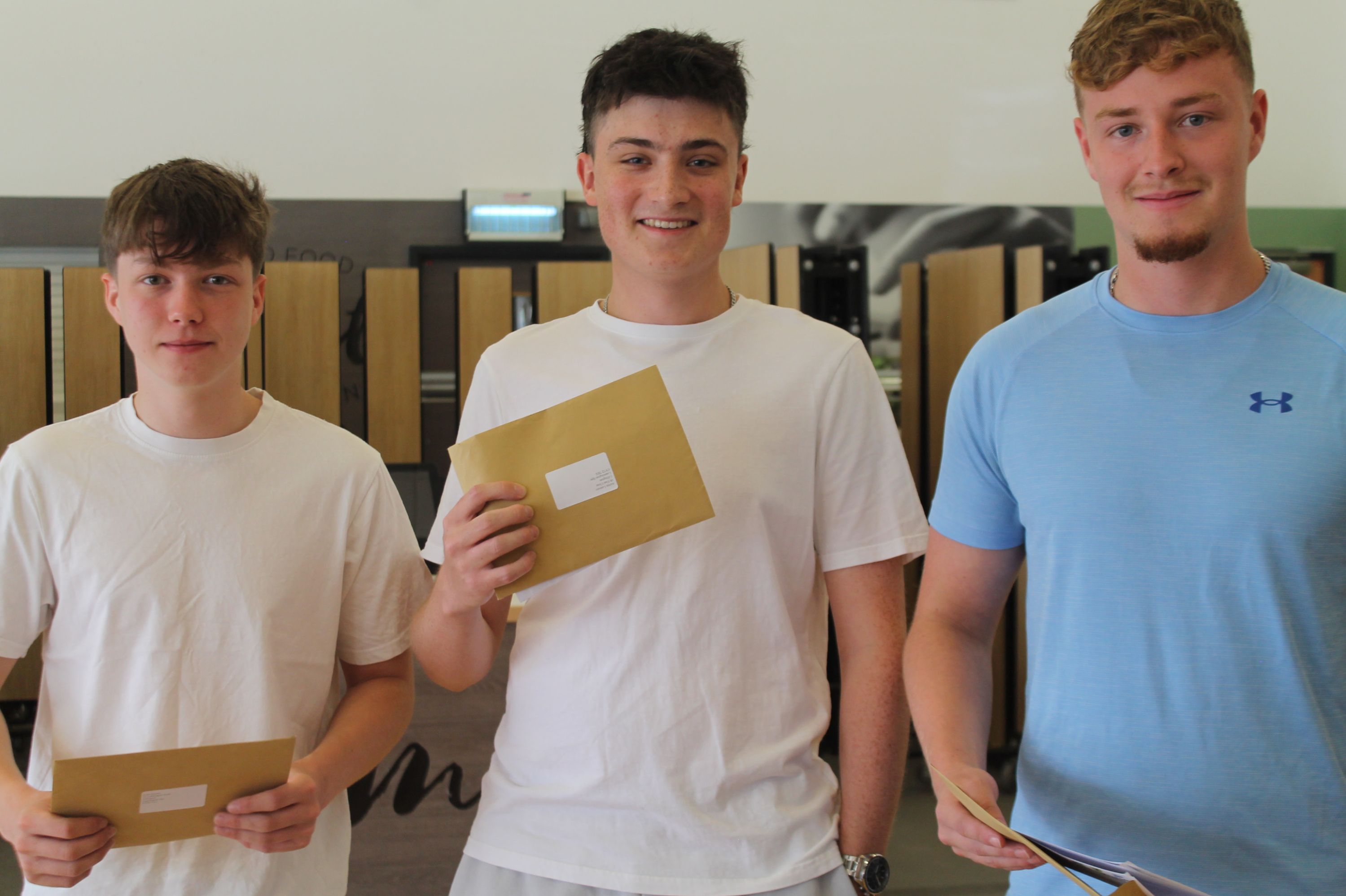 three students celebrating their A Level Results
