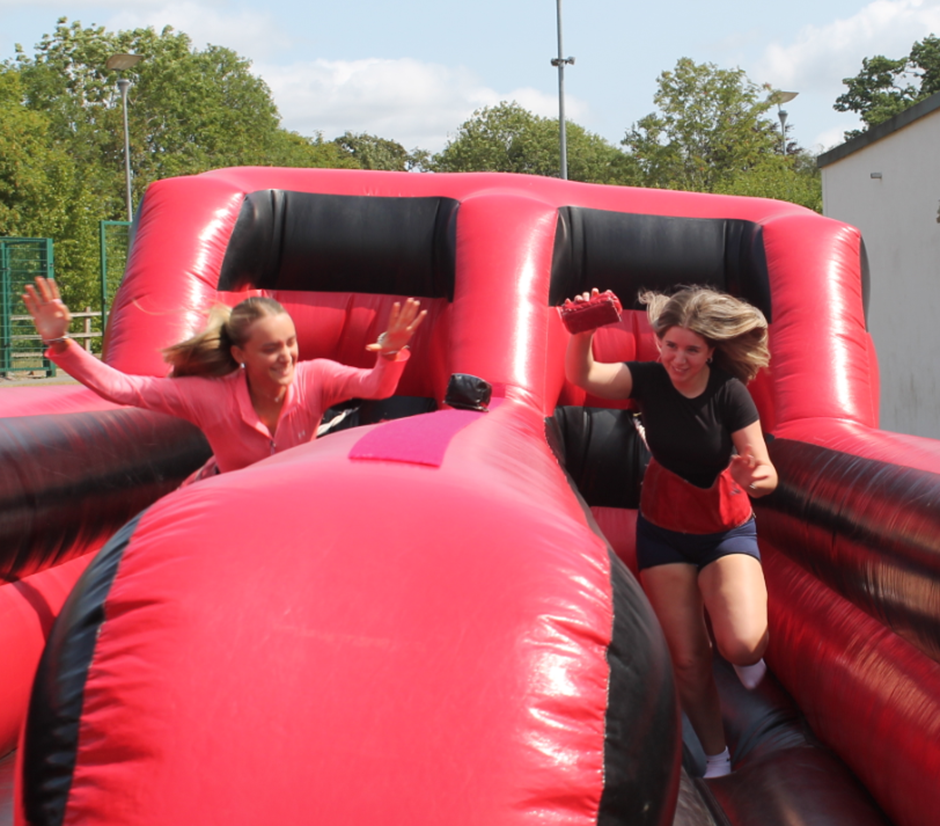 two students enjoying the inflatables