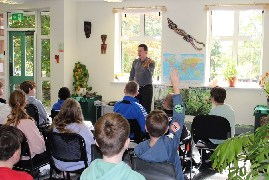students listening to a member of staff at the botanical gardens