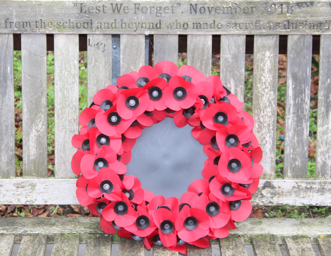 Poppy wreath laid on a bench