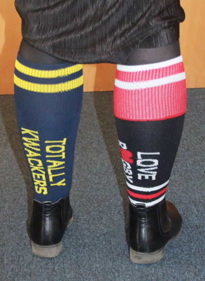 Staff member's legs showing rugby socks labelled Totally Kwackers and Love Rugby