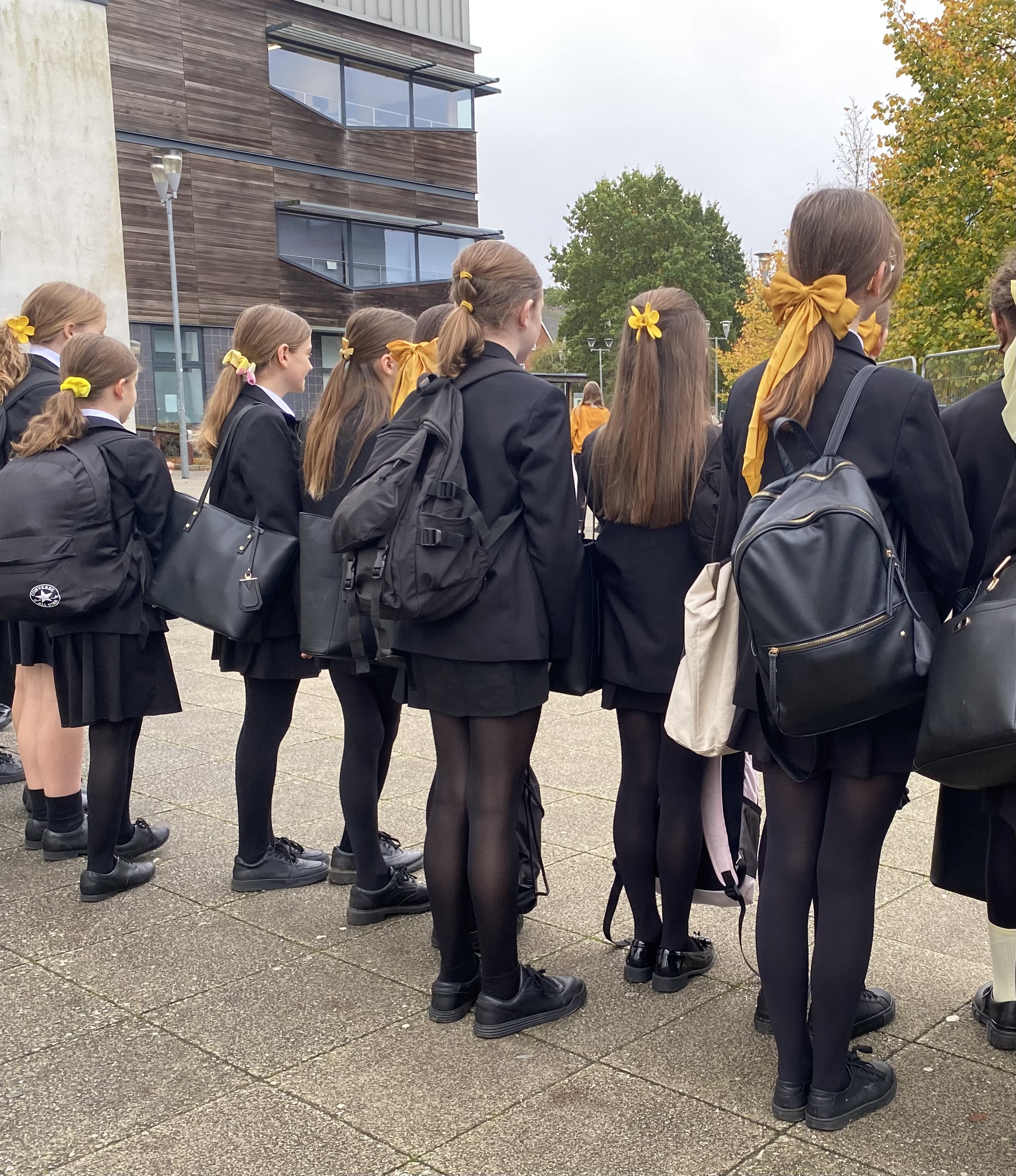 A group of girls wearing yellow hair accessories