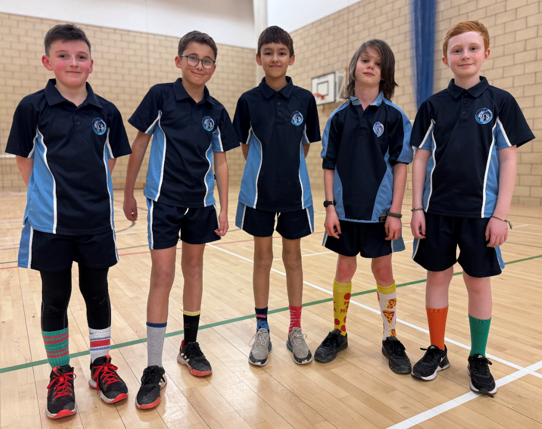 Group of boys in PE kit wearing colourful odd socks