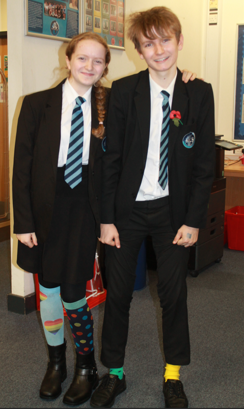 two students wearing their NLS uniform and odd coloured socks