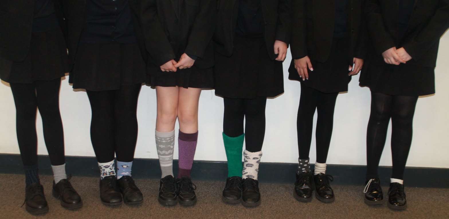 A group of students showing legs and feet wearing odd socks