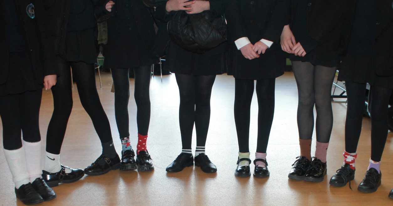 A group of students only legs and feet wearing odd socks