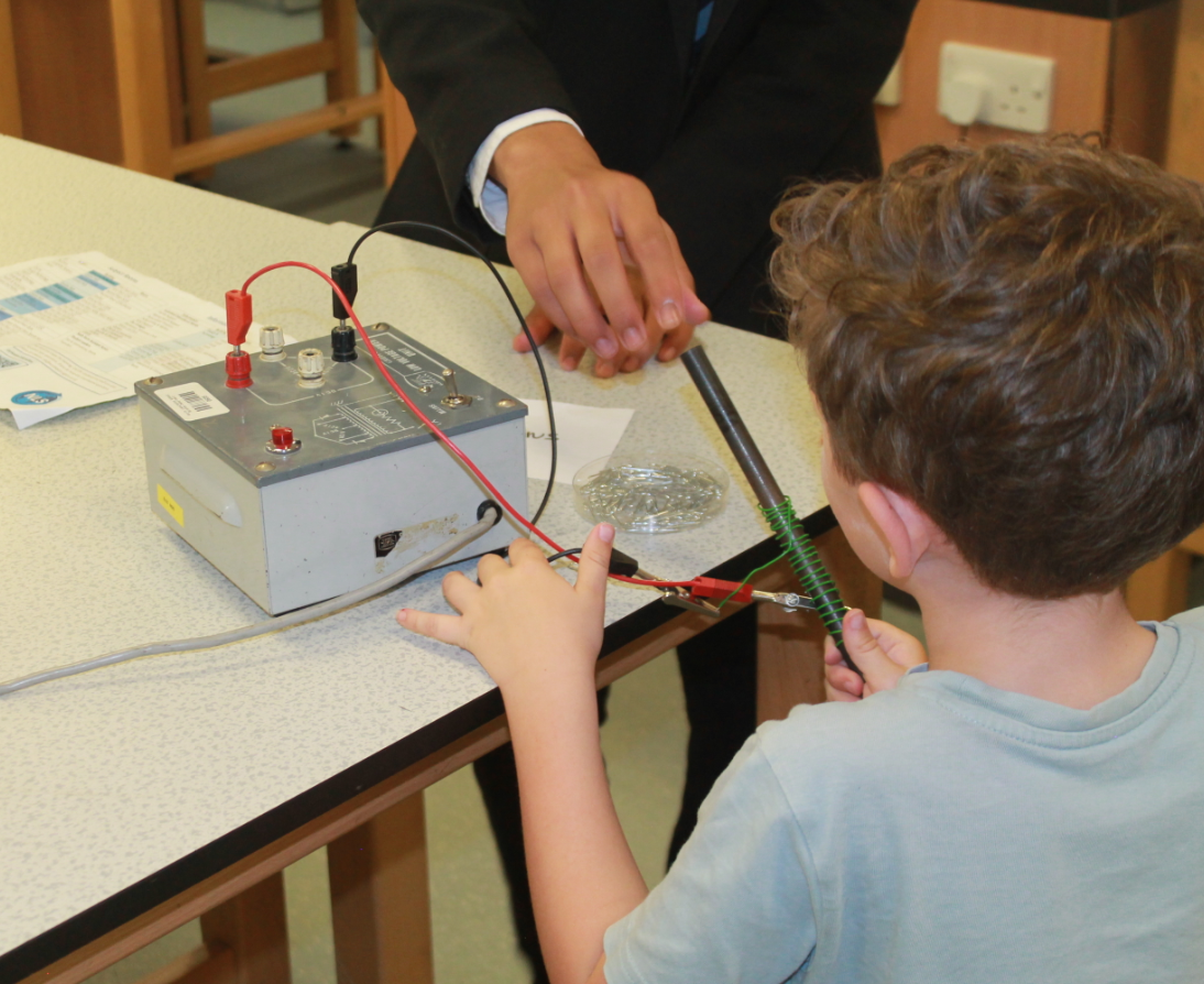 a boy learning about metals in physics