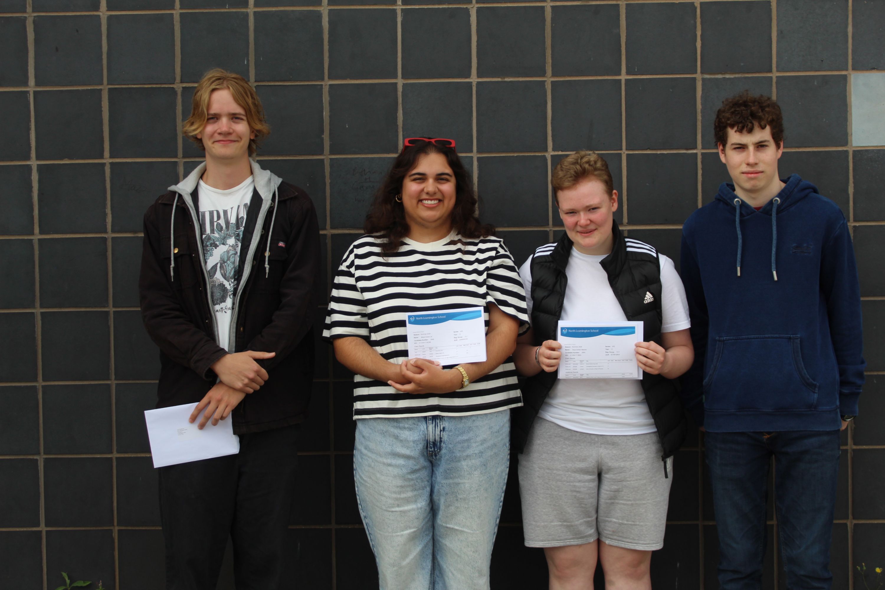 Four students with their A Level results