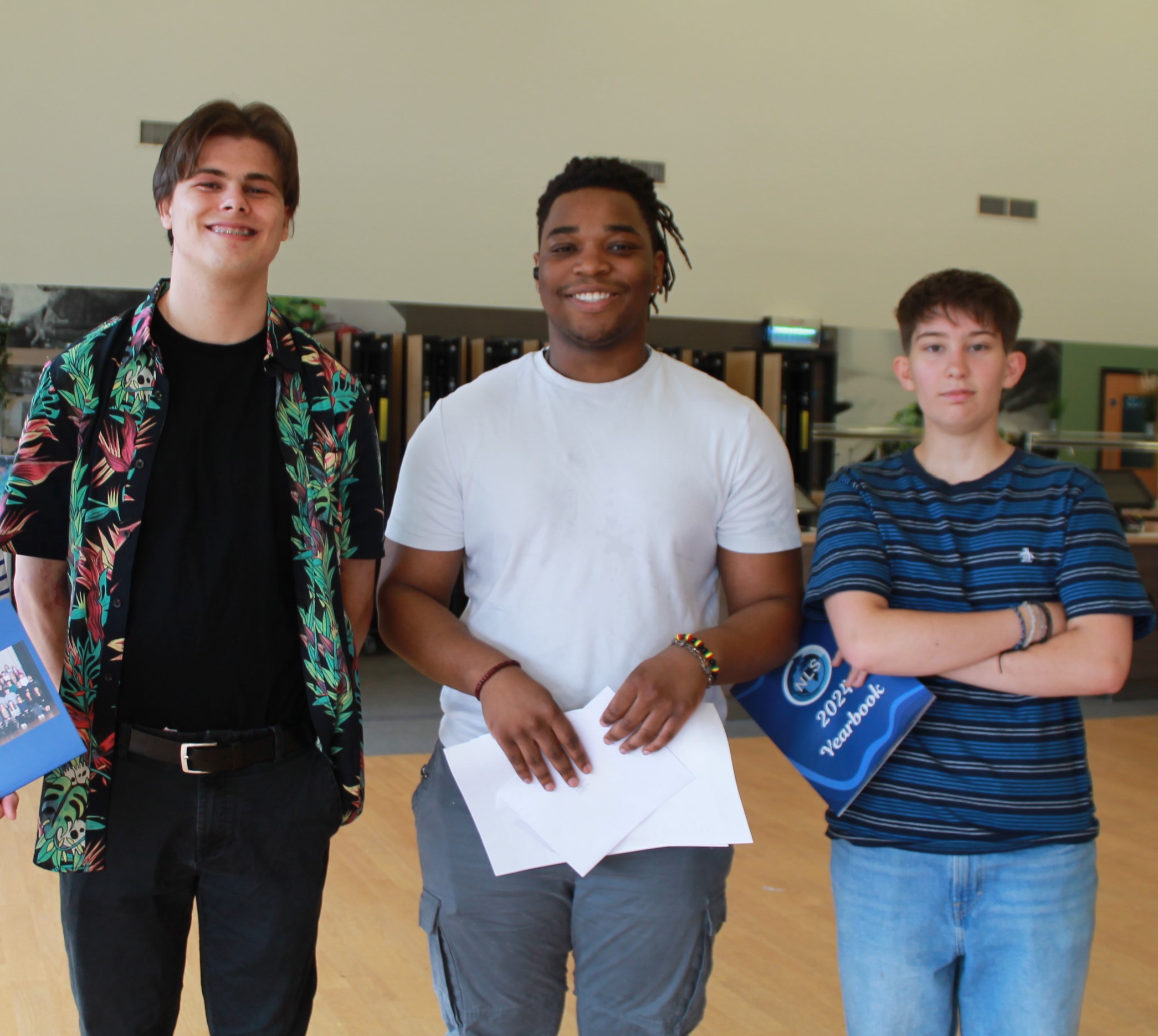 Three students with their A Level results