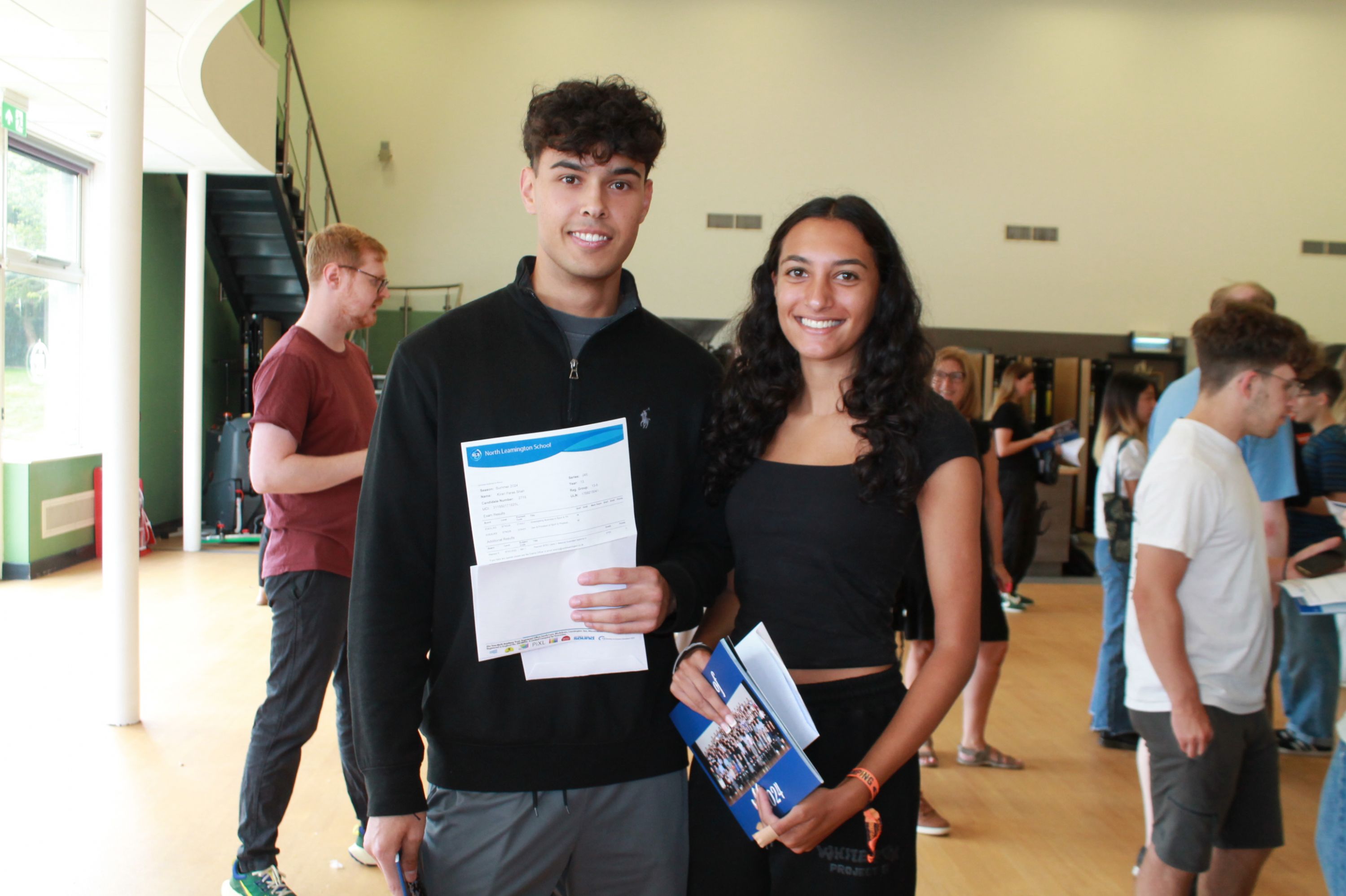 Two students with their A Level results