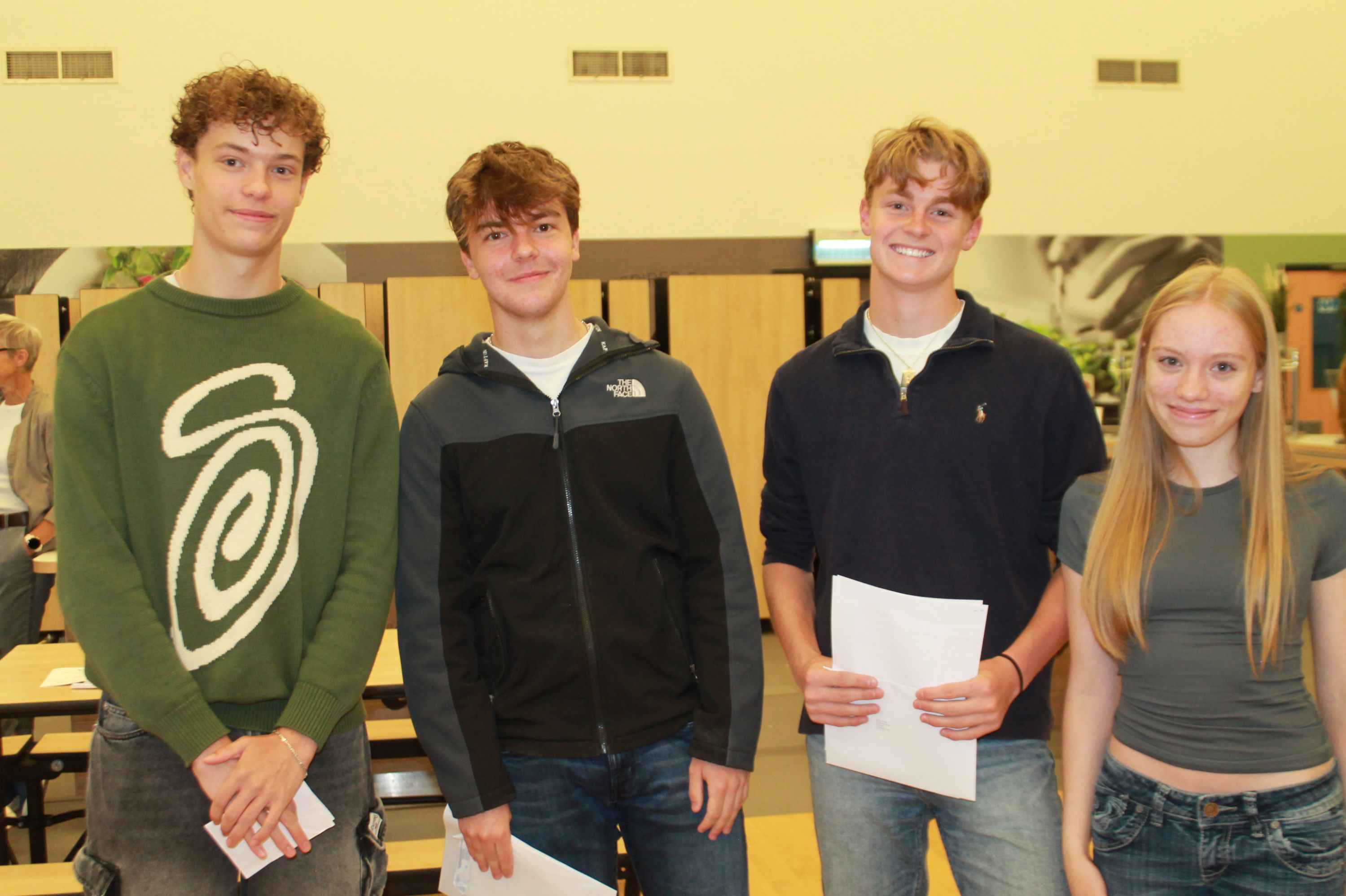 Four students with their GCSE results